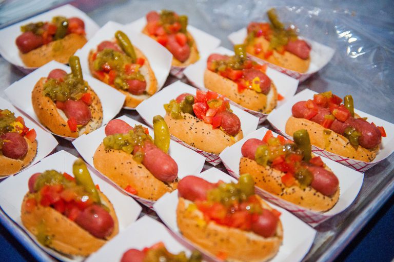 Mini hot dogs on a paper tray.