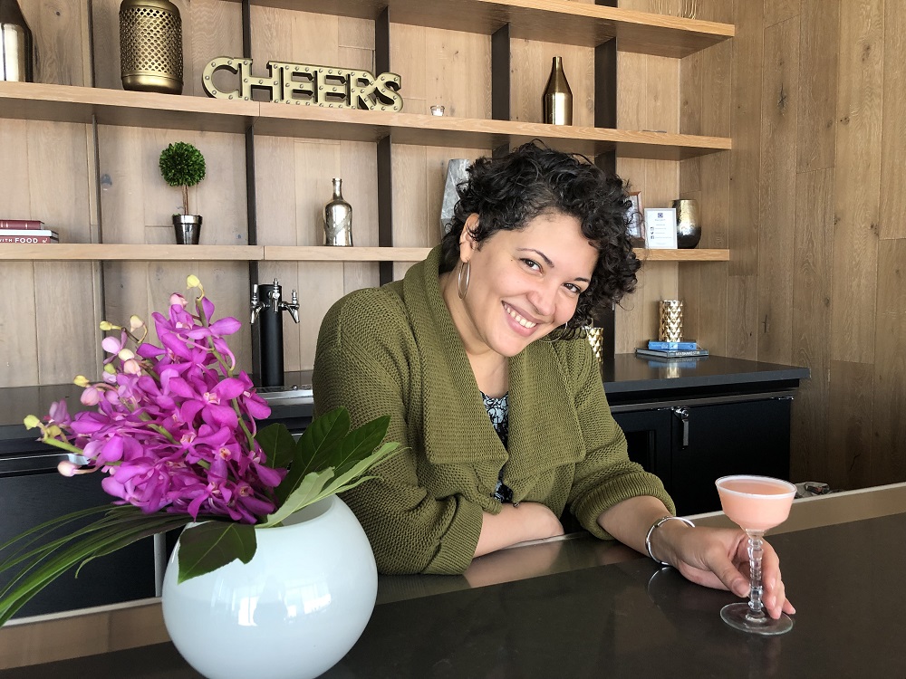 A woman holding a drink in her hand.