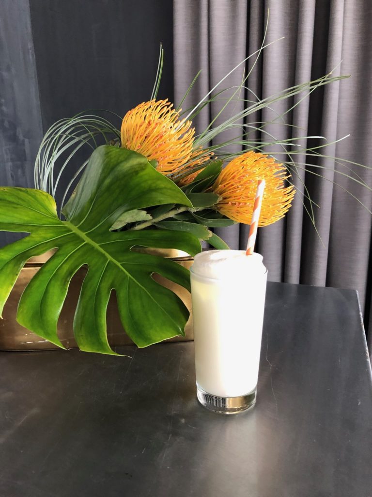 An alcoholic beverage in a highball drinking glass.